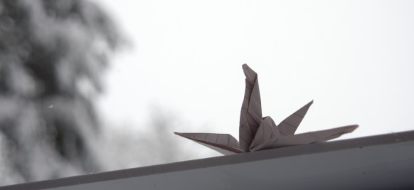 Paper crane contemplating